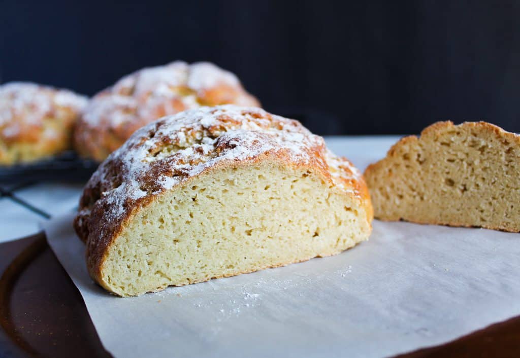 Gluten free artisan bread sliced on a cutting board.