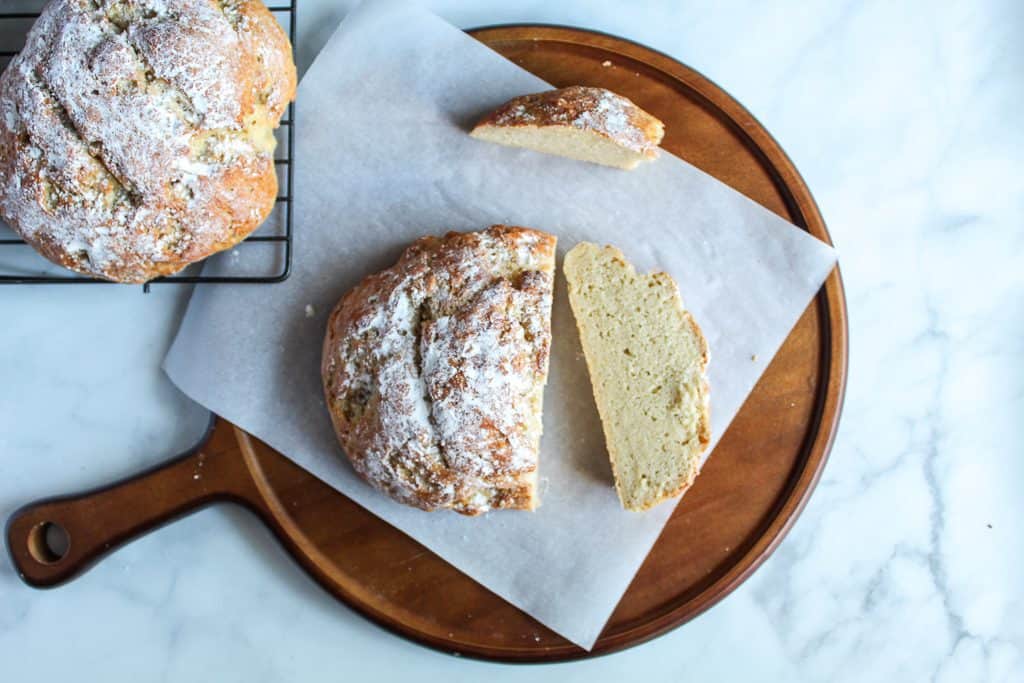 gluten free artisan bread sliced on a wooden board