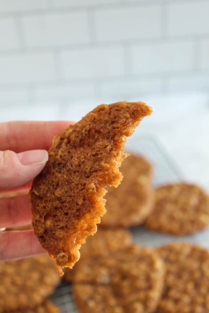 showing a bite our of an Anzac biscuit