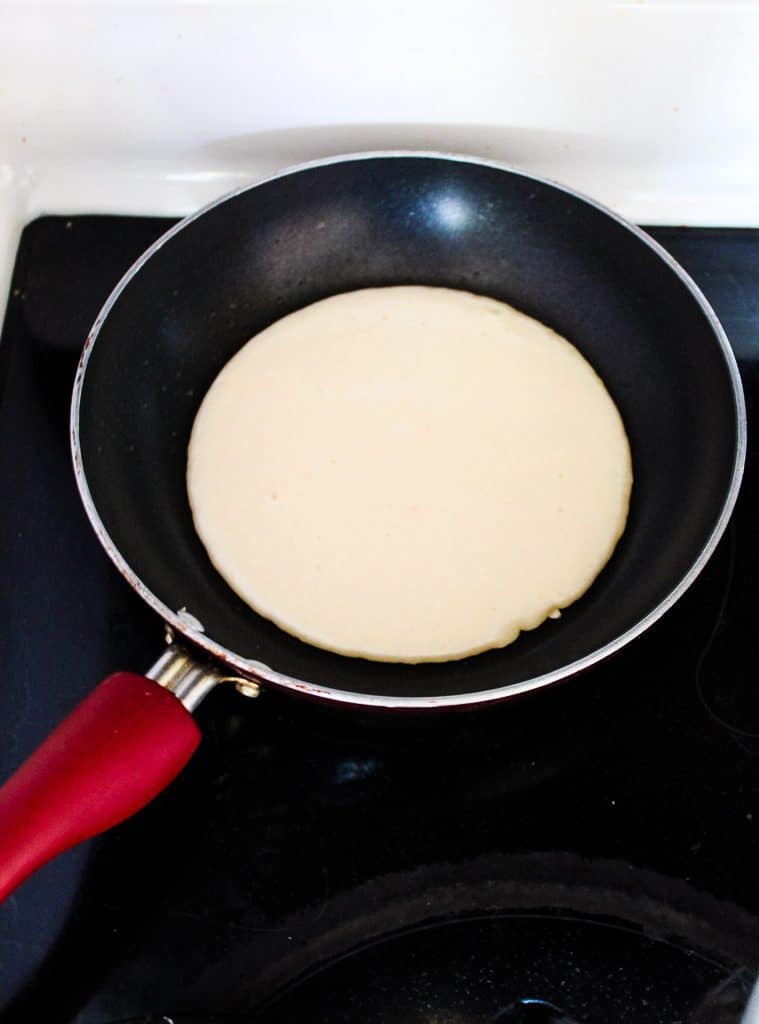 Cooking gluten free pita bread in a skillet on the stove