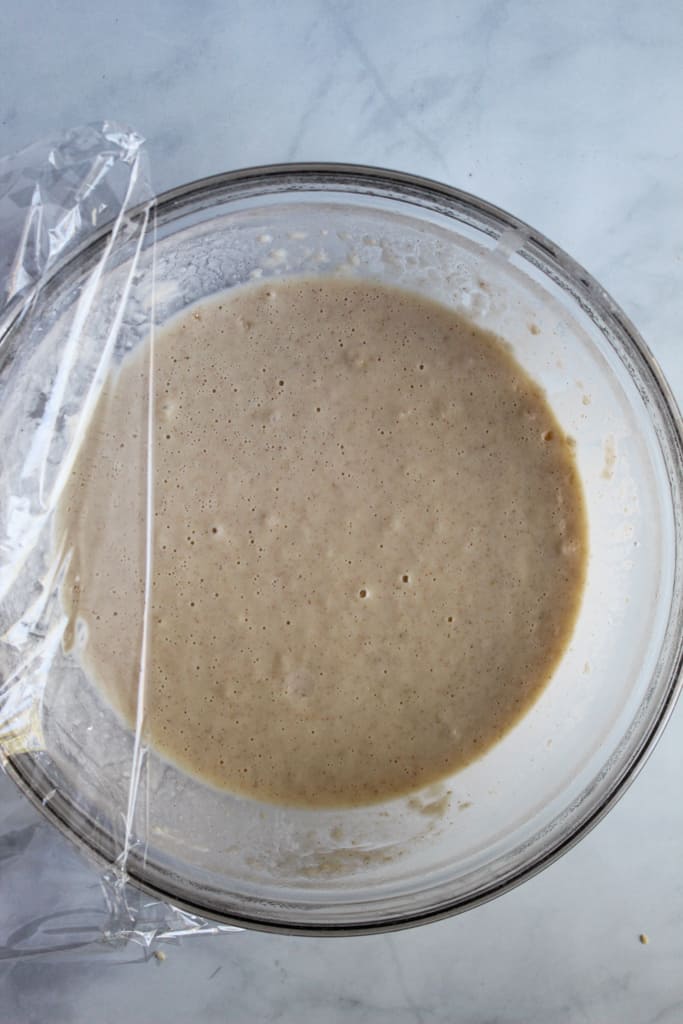gluten free belgian waffles batter risen in a glass bowl