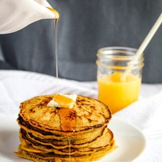 plate of gluten free buckwheat pancakes with syrup and butter