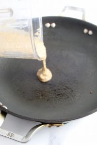 shot of pouring pancake batter on a skillet