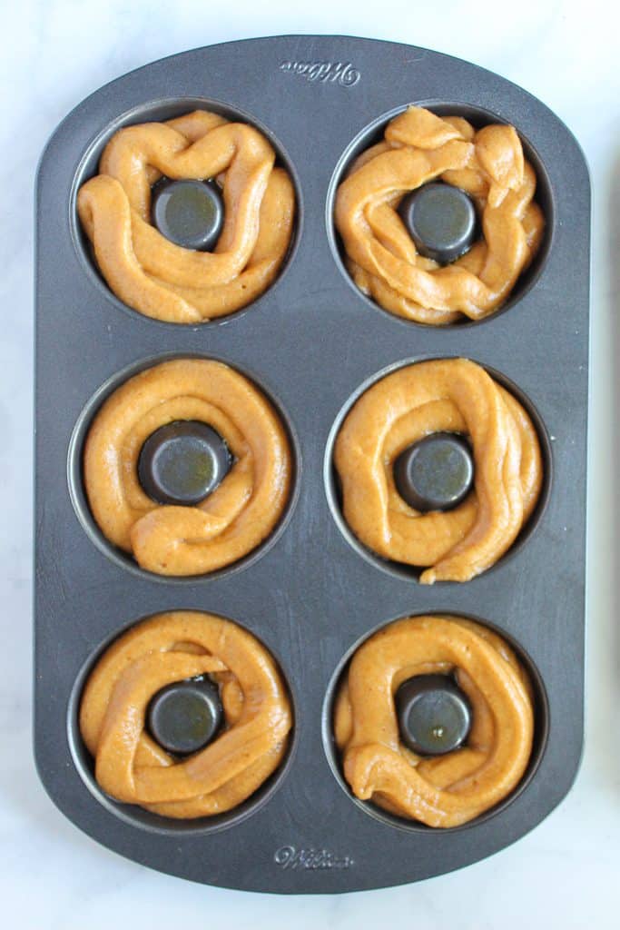 gluten free pumpkin donuts in a baking pan