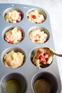gluten free strawberry muffins portioned in a 12 cup muffin pan