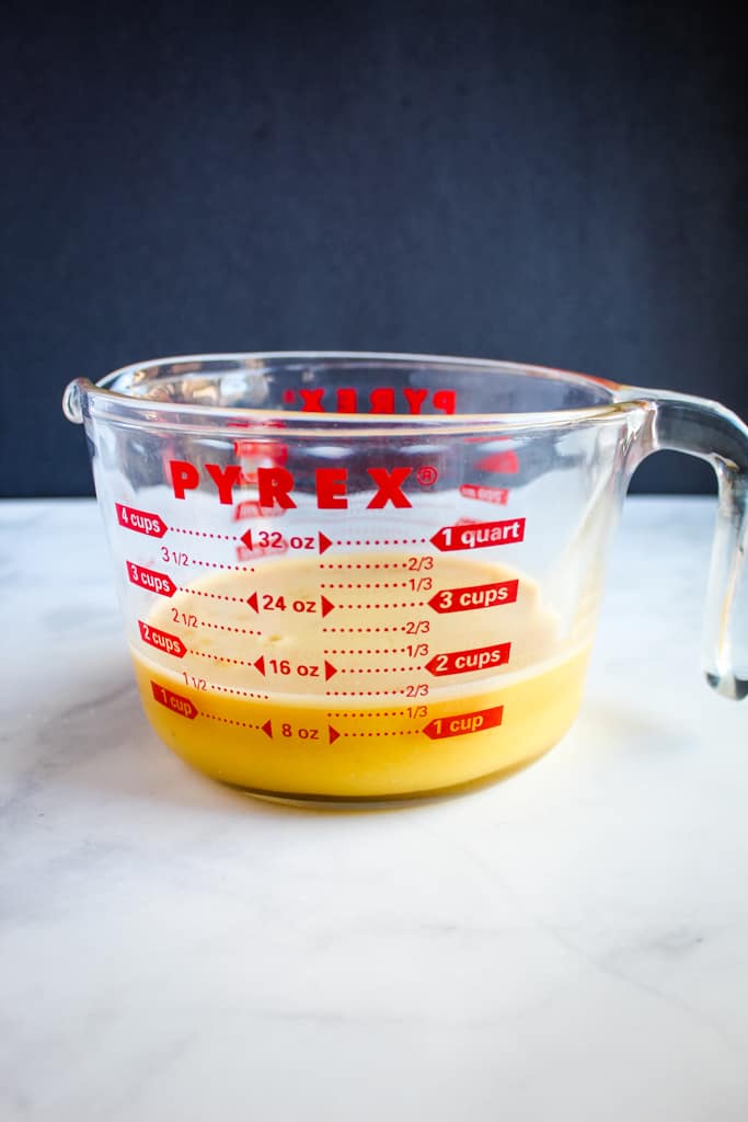 gluten free crepes batter in a glass measuring cup