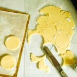overhead shot of cookie dough rolled out and cut with cutters