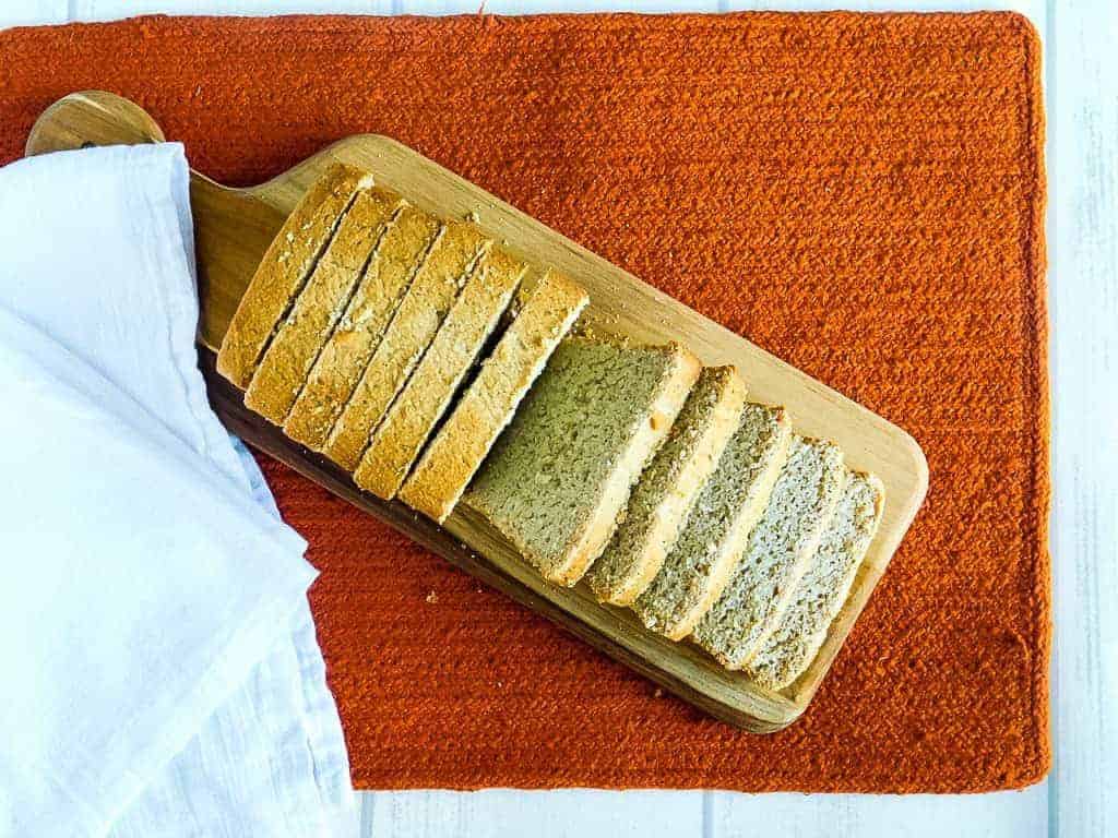gluten free vegan sandwich bread on a cutting board on an orange towel