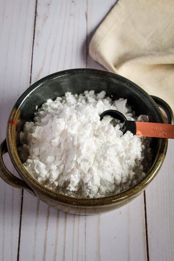 bowl of potato starch on a wooden counter