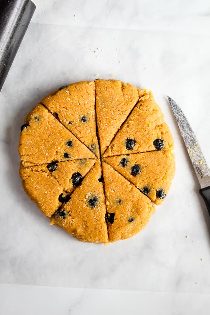 gluten free lemon blueberry scones sliced dough on a white countertop