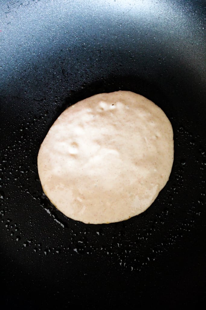 rice flour pancakes cooking in a skillet