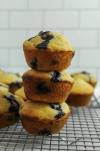 gluten free banana blueberry muffins stacked on a wire rack