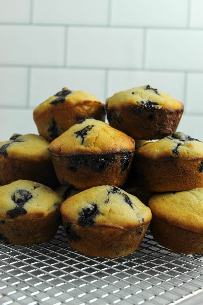 gluten free banana blueberry muffins stacked on a wire rack