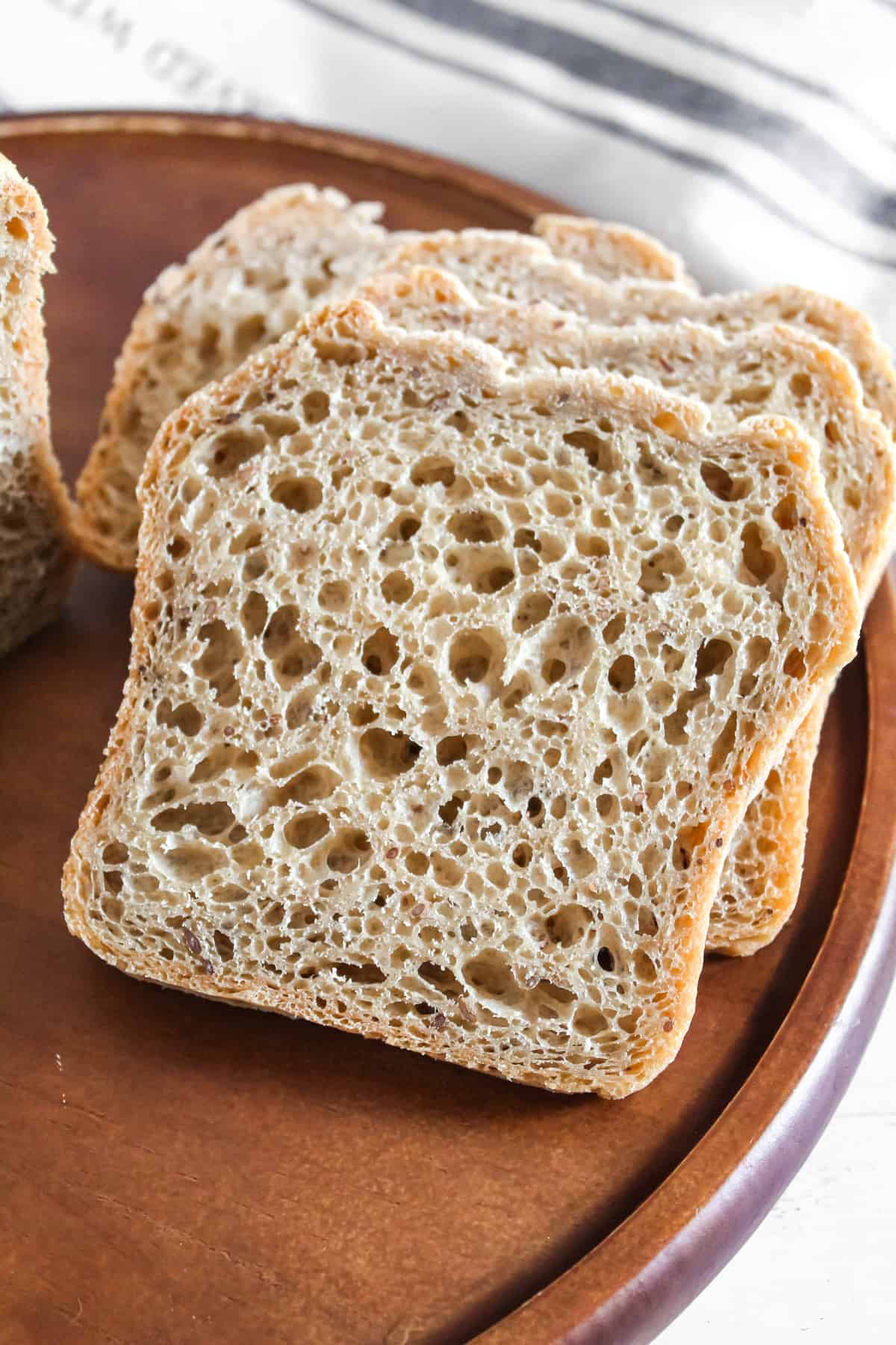 baked slice of bread on a brown cutting board