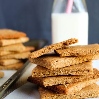 low carb gluten free graham crackers stacked on a baking pan.