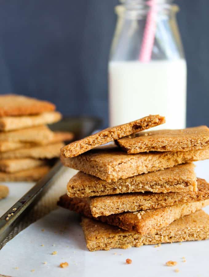 low carb gluten free graham crackers stacked on a baking pan.