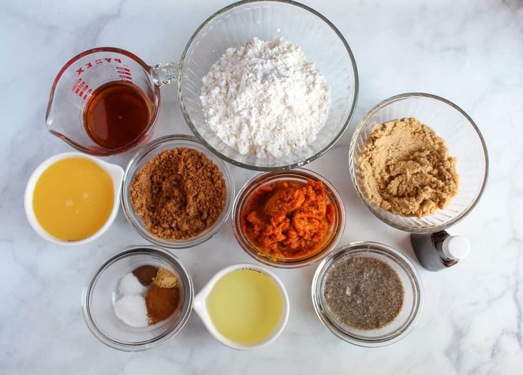 vegan pumpkin muffins ingredients on a white counter.