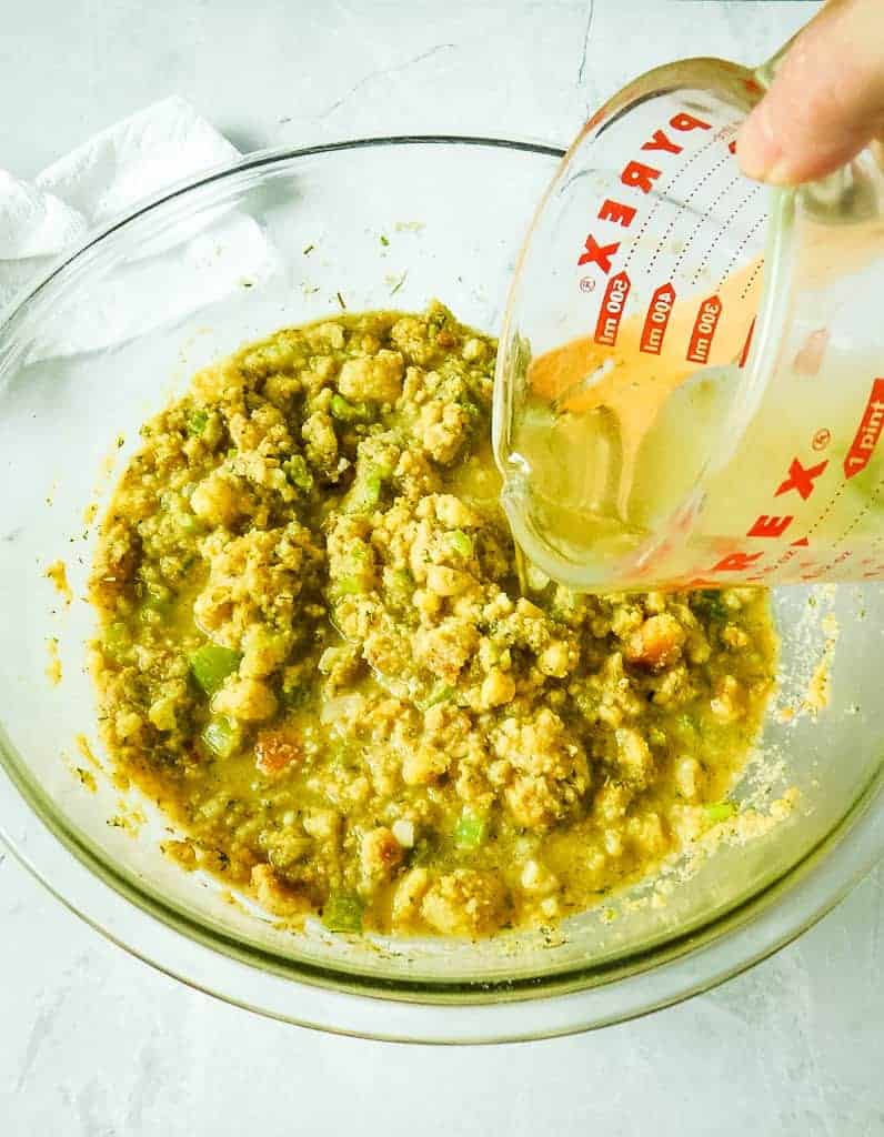 cornbread mix in a clear bowl on a white counter