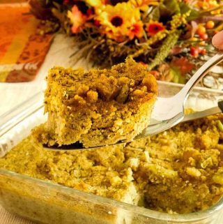 cornbread dressing sliced from the pan on a silver serving spoon