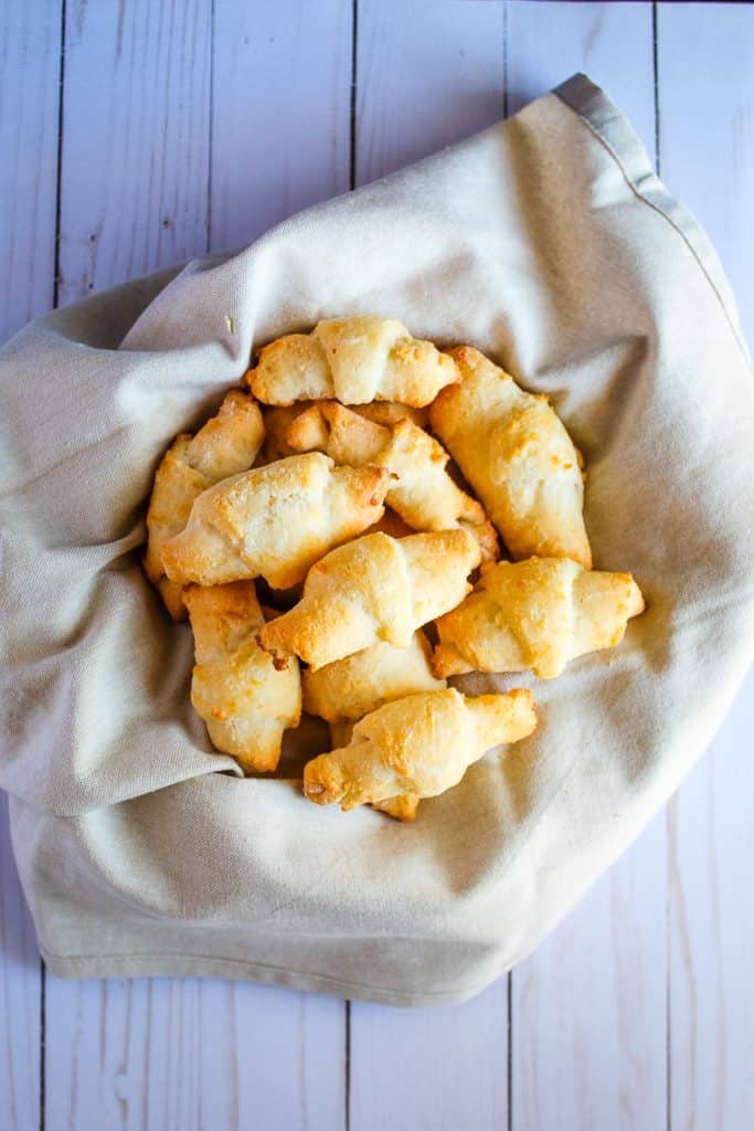 Gluten free crescent rolls in a basket on a counter