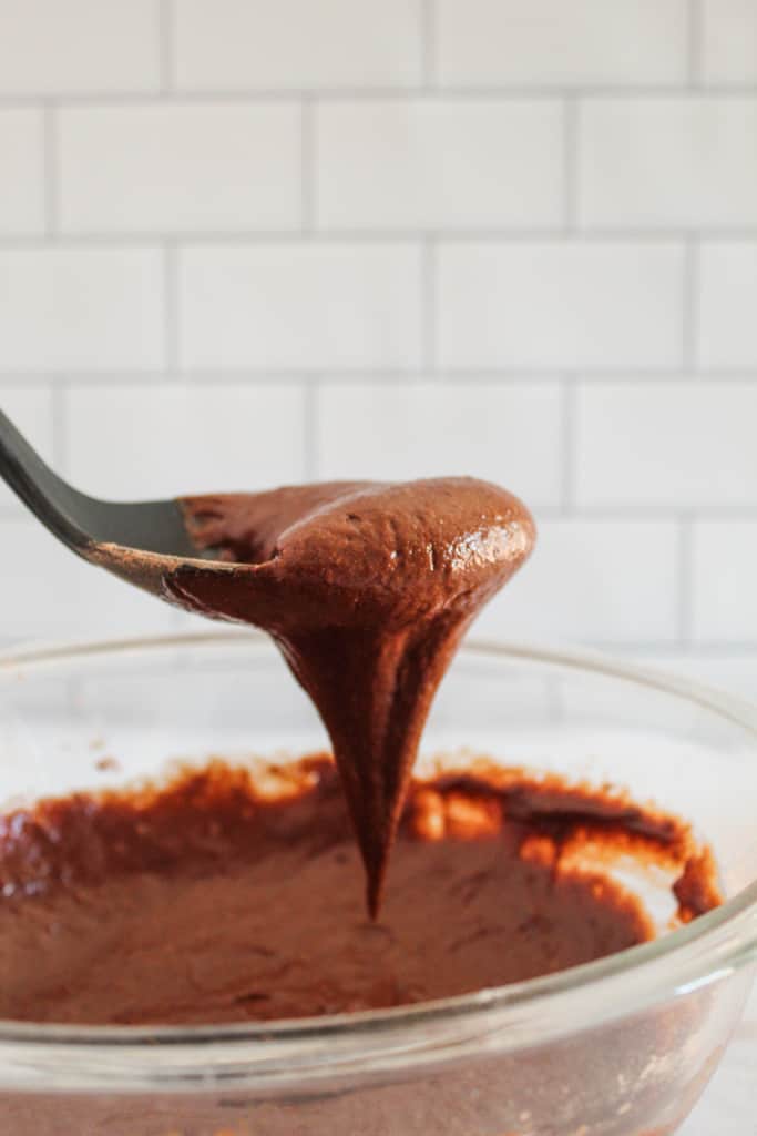 side shot of batter dripping off spoon