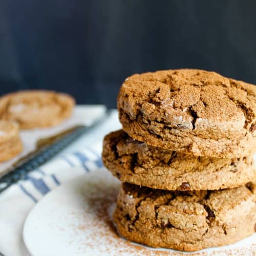 gluten free chocolate biscuits stacked on a white plate.