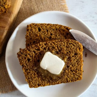 overhead shot of brown bread on a plate with butter
