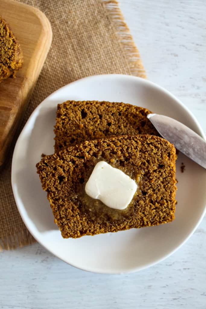 overhead shot of brown bread on a plate with butter