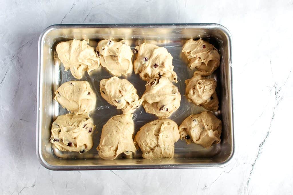 gluten free hot cross buns portioned out in a baking pan