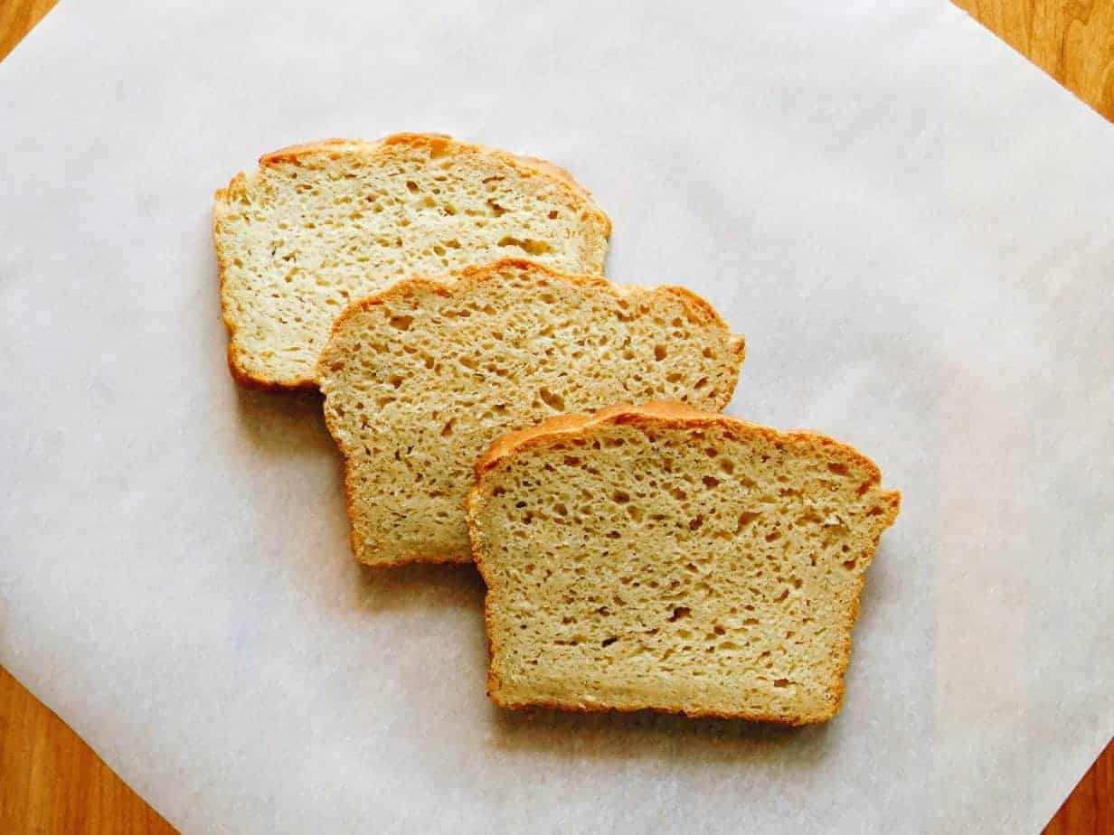 three slices of gluten-free Italian bread on a parchment paper