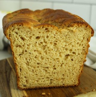 gluten free hawaiian bread sliced on a brown cutting board