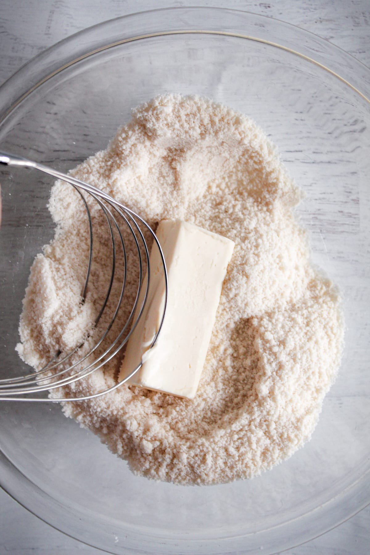 cutting butter into dry ingredients in a bowl