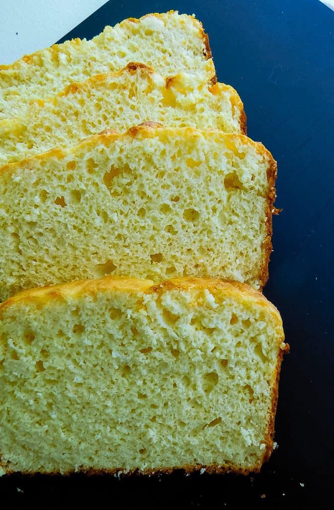 slices of low carb bread on a black cutting board