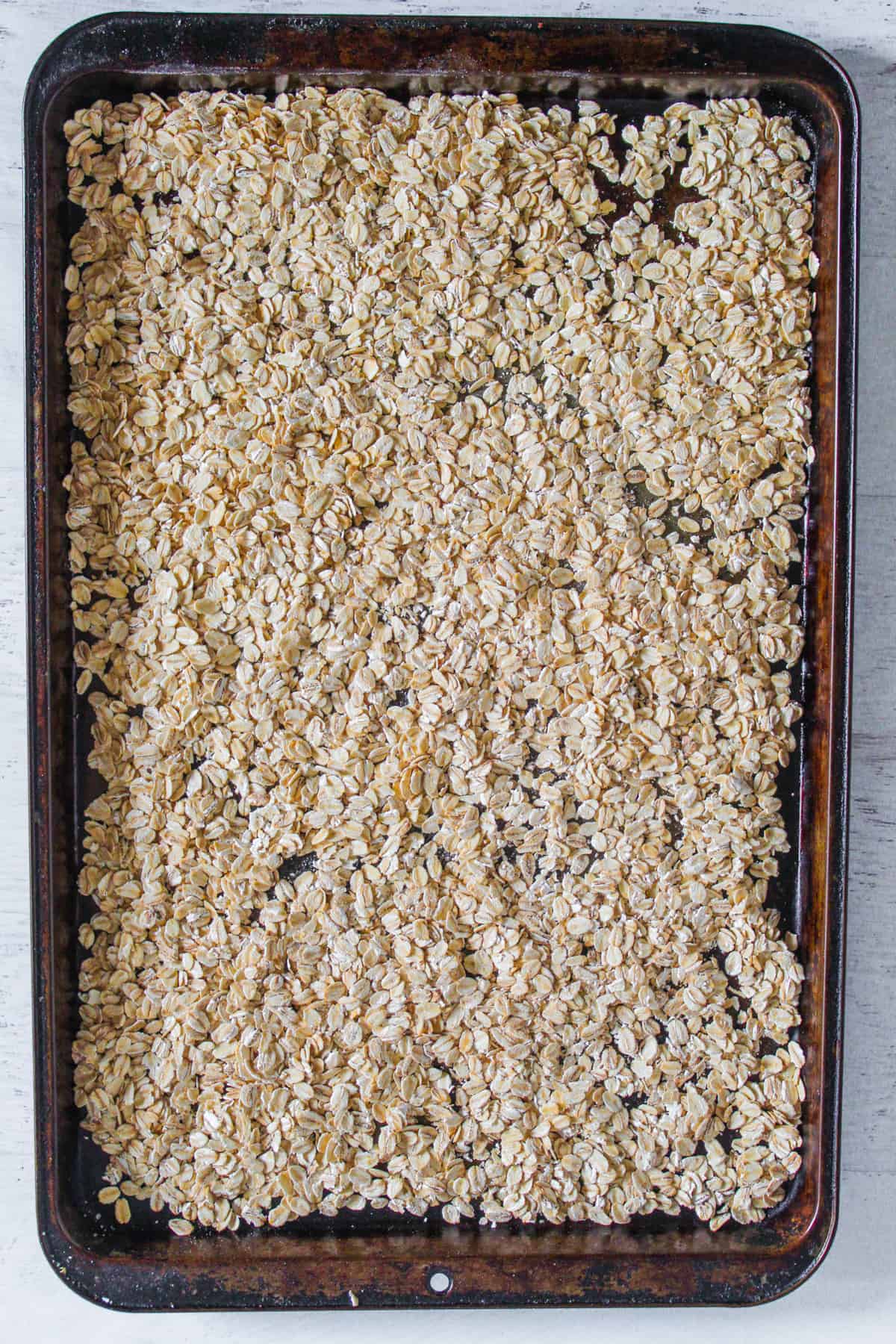toasting oats on a baking sheet