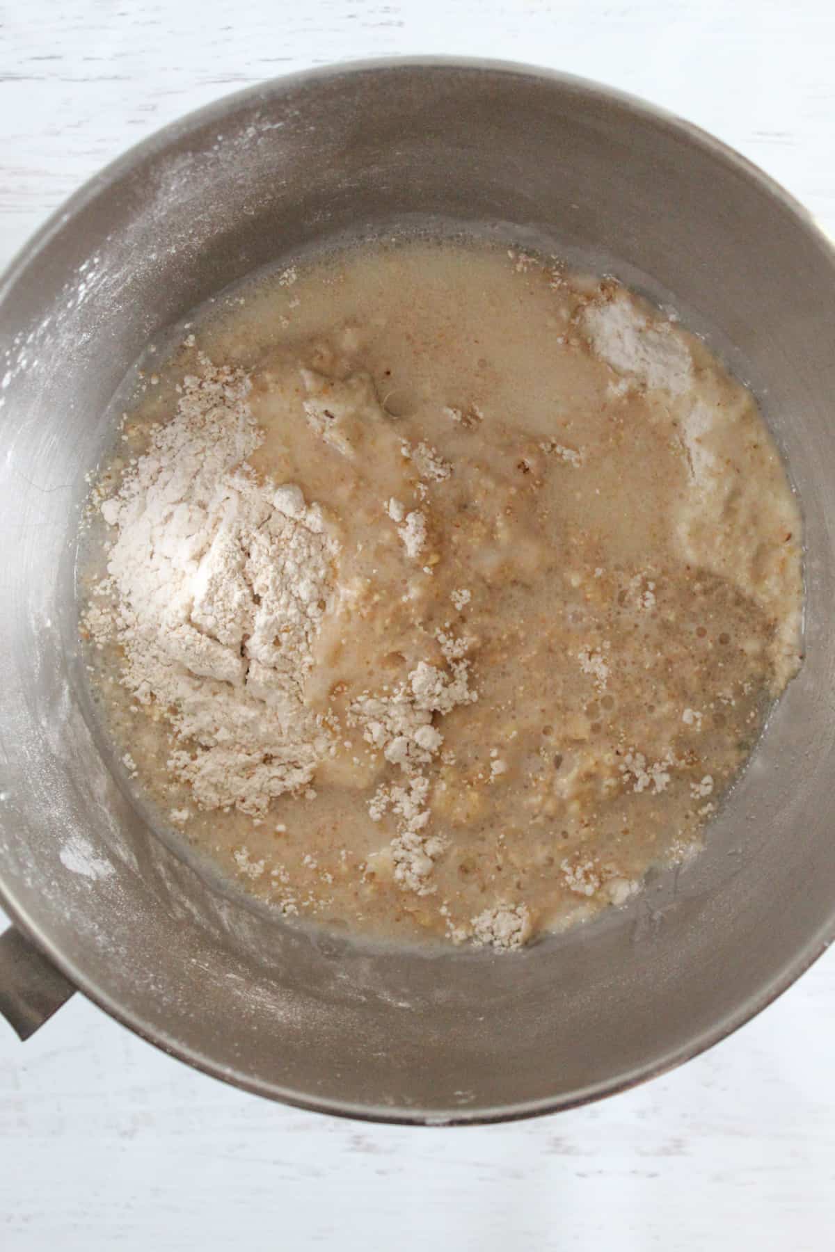 adding liquid to a flour mixture in a bowl