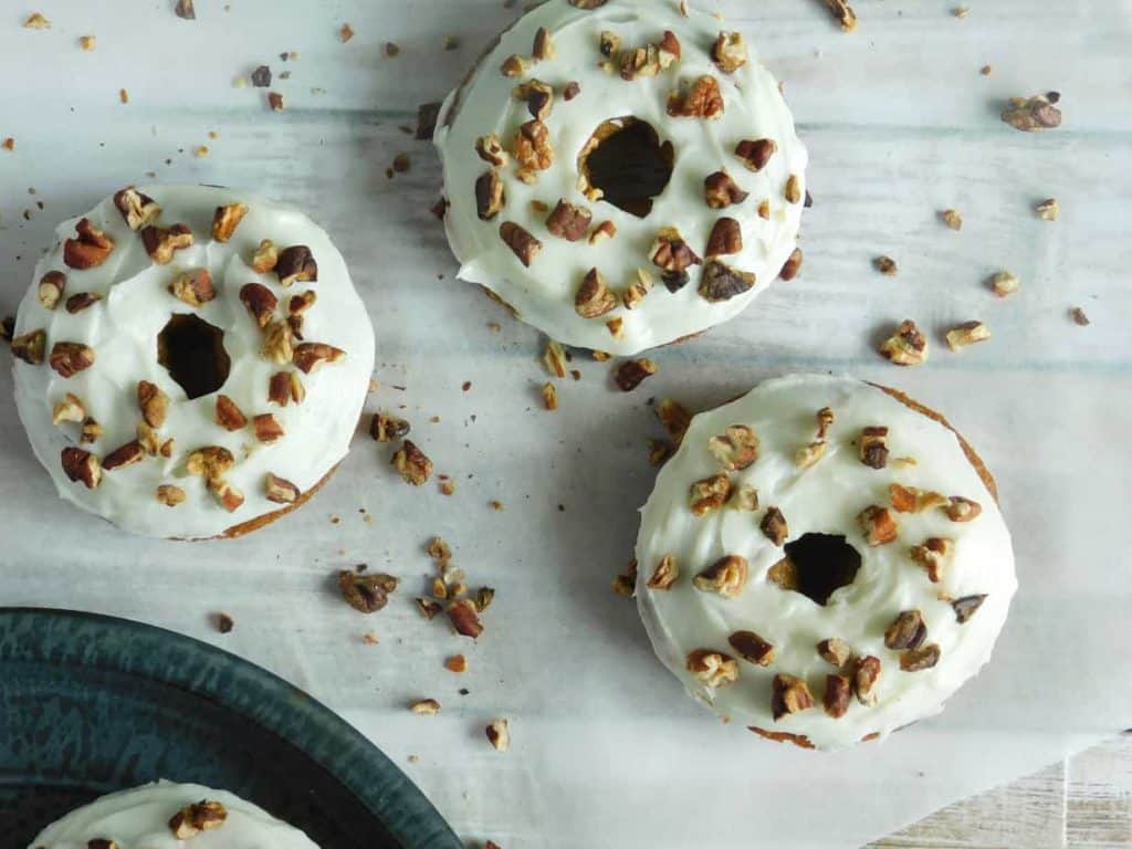donuts sprinkled with pecans on a white paper