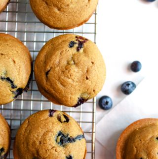 gluten free lemon blueberry muffins sitting on a wire rack