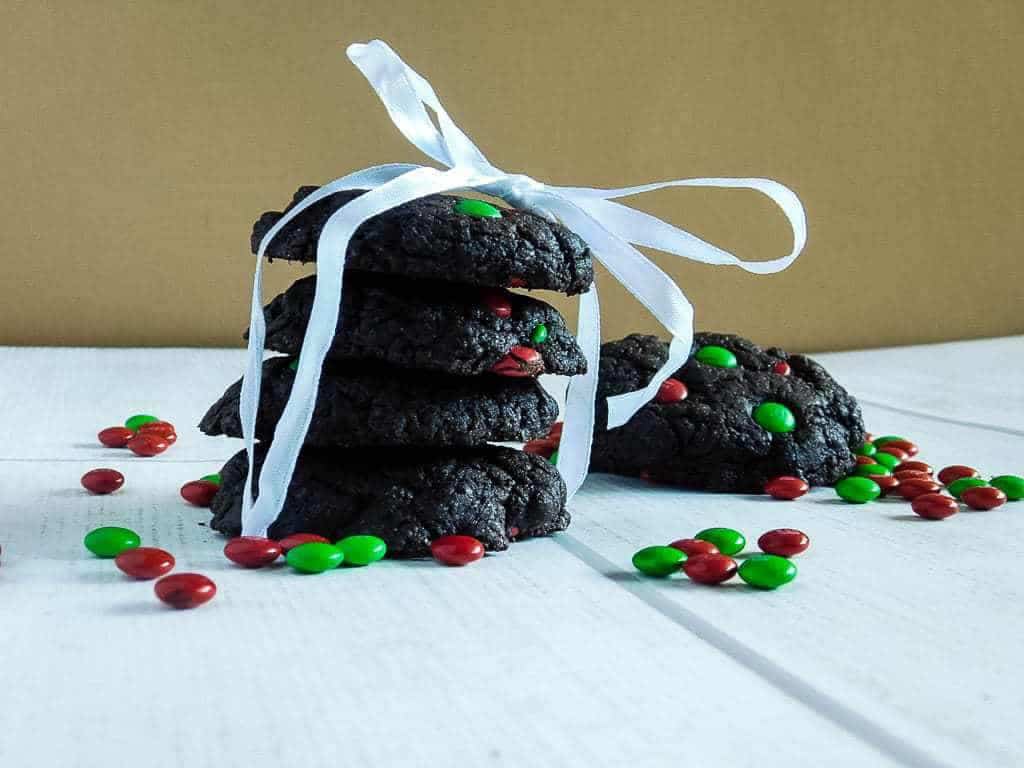 gluten free chocolate cake cookies wrapped in a ribbon on a white board