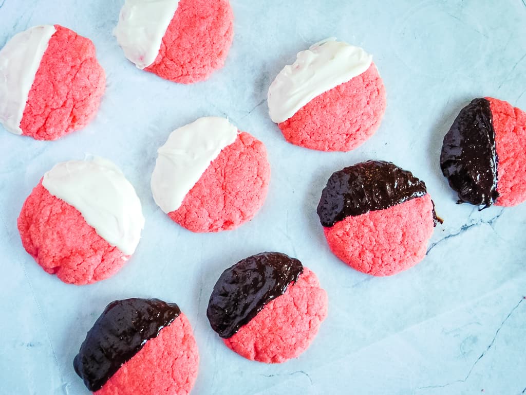 cookies dipped in white chocolate and chocolate on a cookie sheet