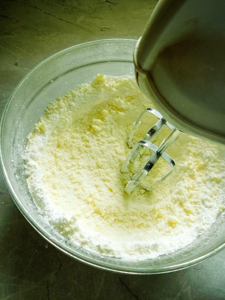 mixing frosting in a glass bowl