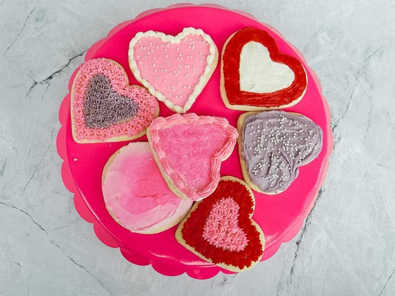 frosted cookies on a pink serving dish