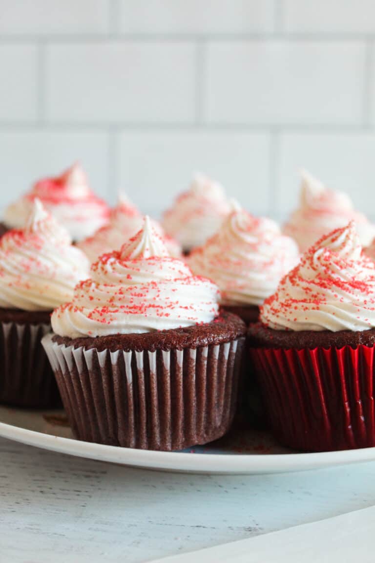 plate of frosted cupcakes