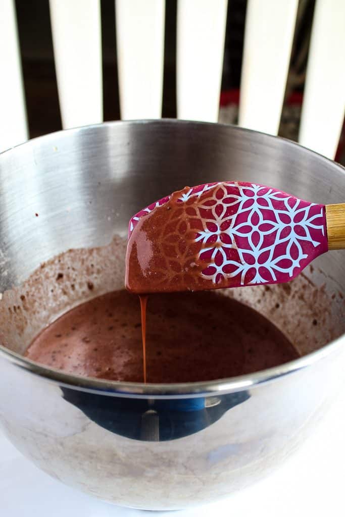 showing consistency of gluten free red velvet cupcakes on a rubber spatula