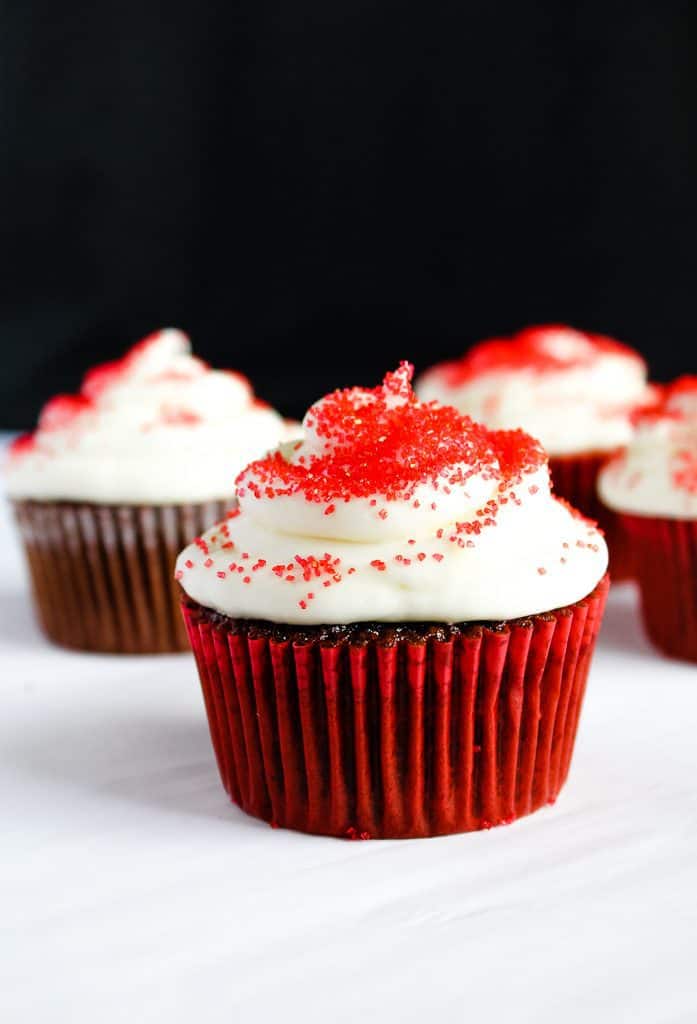 single gluten free red velvet cupcake on a white counter