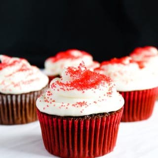 gluten free red velvet cupcakes in a red liner on a white counter