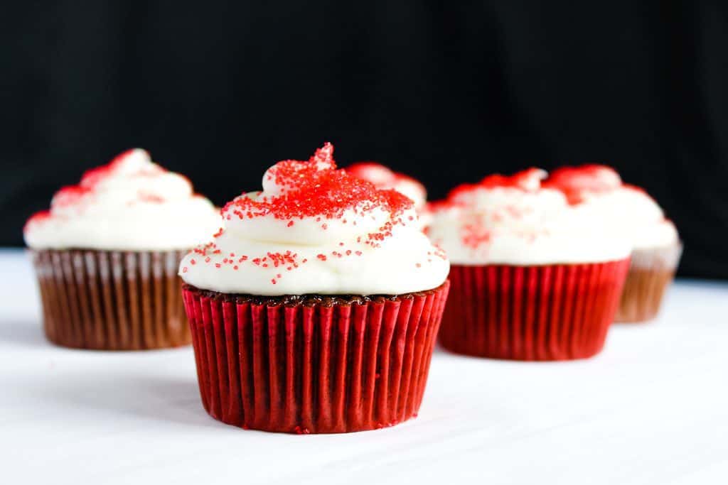 gluten free red velvet cupcakes on a white counter against a black background