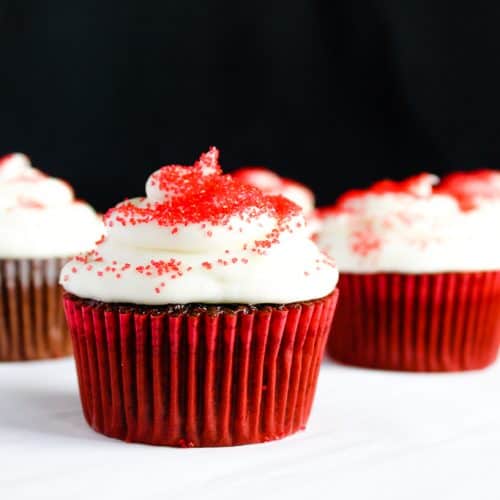 gluten free red velvet cupcakes on a white counter against a black background