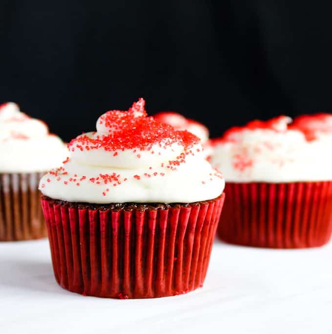 gluten free red velvet cupcakes on a white counter against a black background