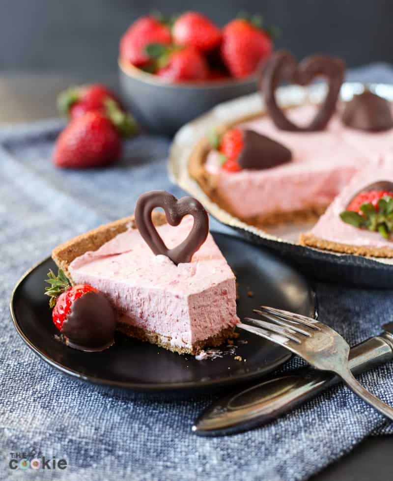 strawberry cheesecake on a black plate