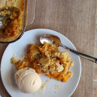 gluten free peach cobbler on a white serving plate.